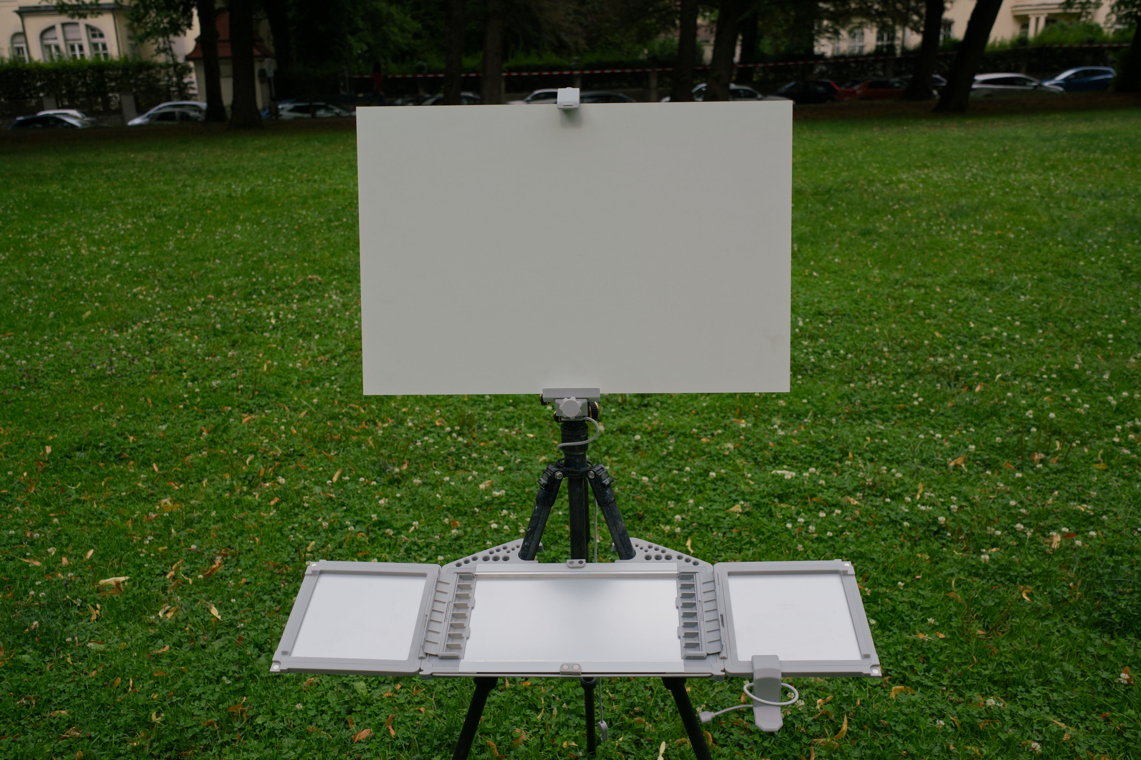 Easel with blank canvas on grass