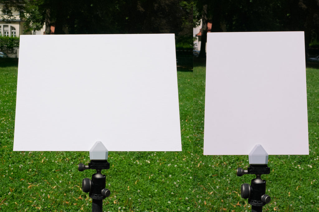 Two white boards on stands with a grassy background