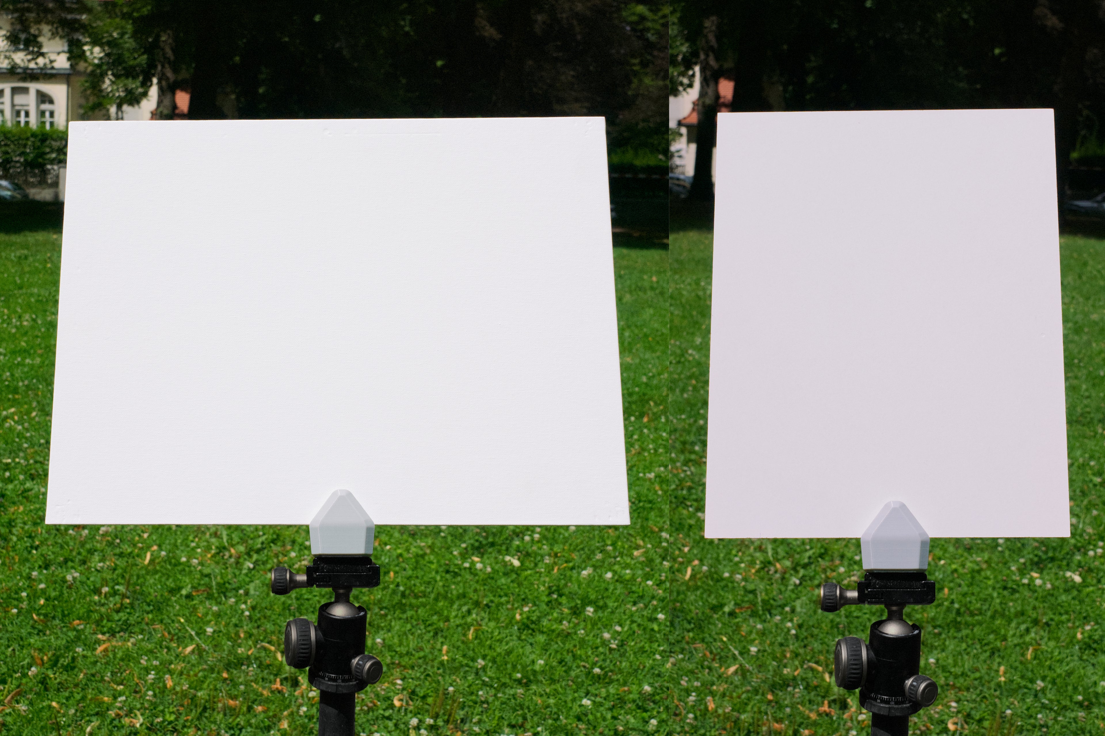 Two white boards on stands with a grassy background
